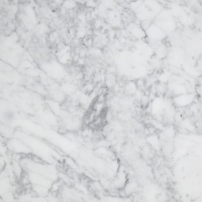 Two square marble tiles, one white with grey veining and the other dark green with light streaks, placed on a white surface.