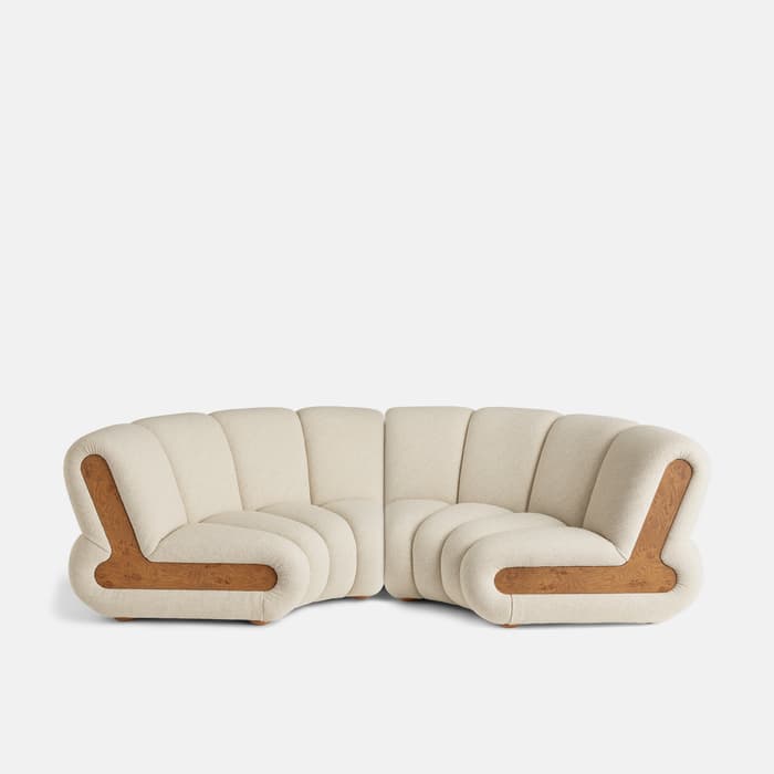 A white, curved sectional sofa with integrated wooden accents, placed against a plain, white background.