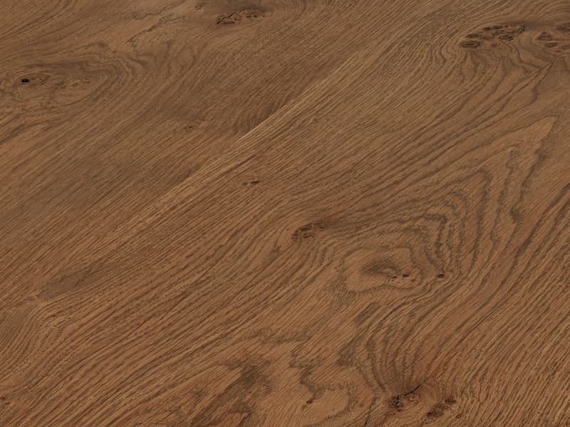 A wooden table features a natural, live-edge design with visible wood grains and knots, blending into a rustic, minimalist environment. The table has a finely sanded and polished surface.