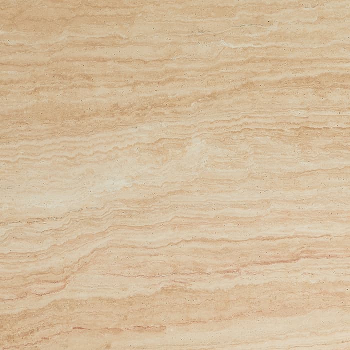 Rectangular wooden cutting board with rounded edges, featuring intricate corner designs, lying flat on a white surface.